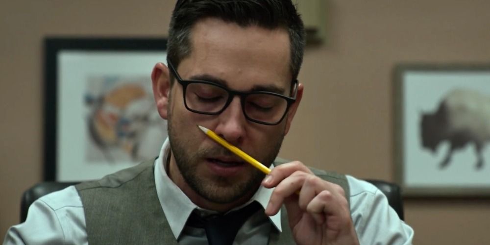 Zachary Levi sniffing a pencil in Office Uprising