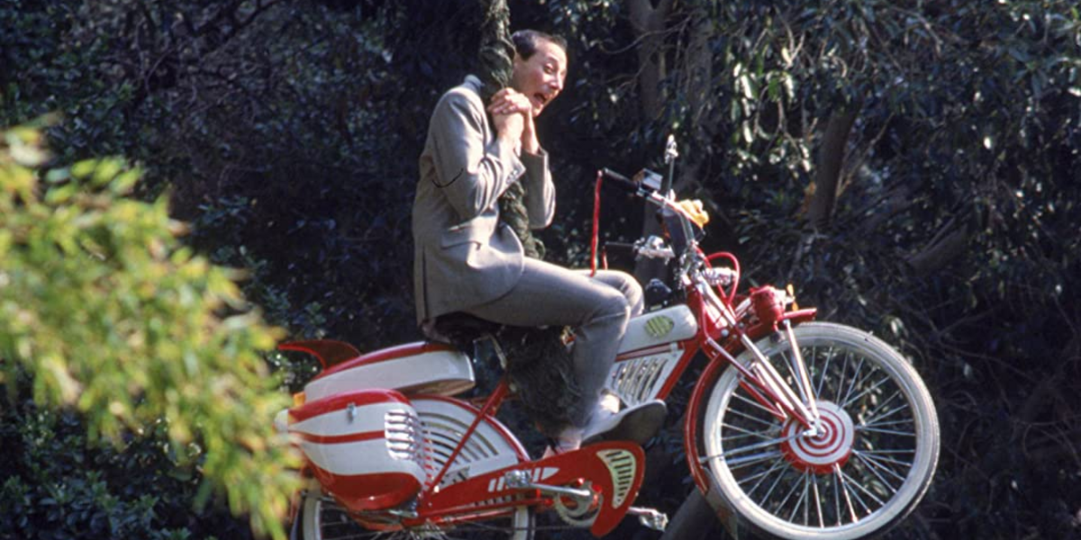 Pee Wee on his bike, dangling from a rope.