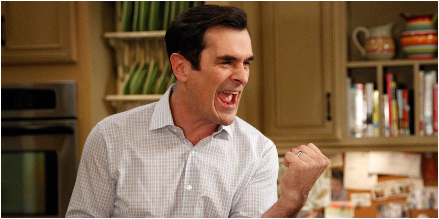 Phil looking happy and holding up his fist on Modern Family