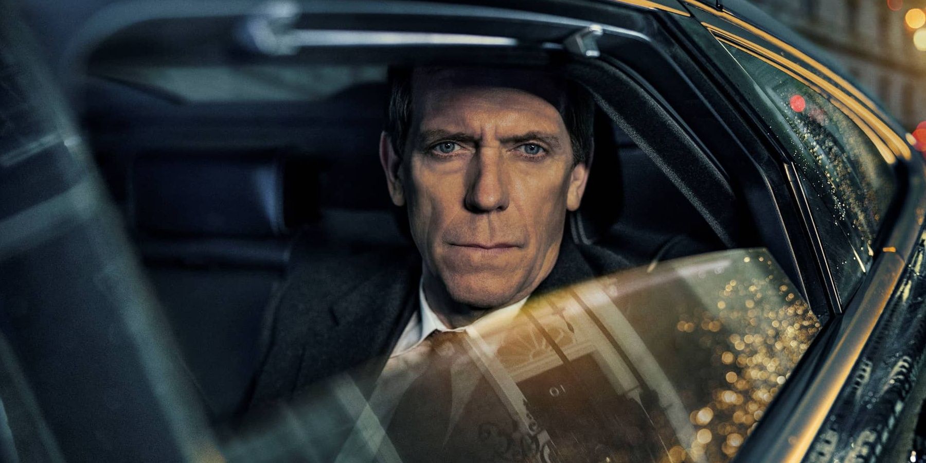 Promo photo of Hugh Laurie in a car for Roadkill miniseries
