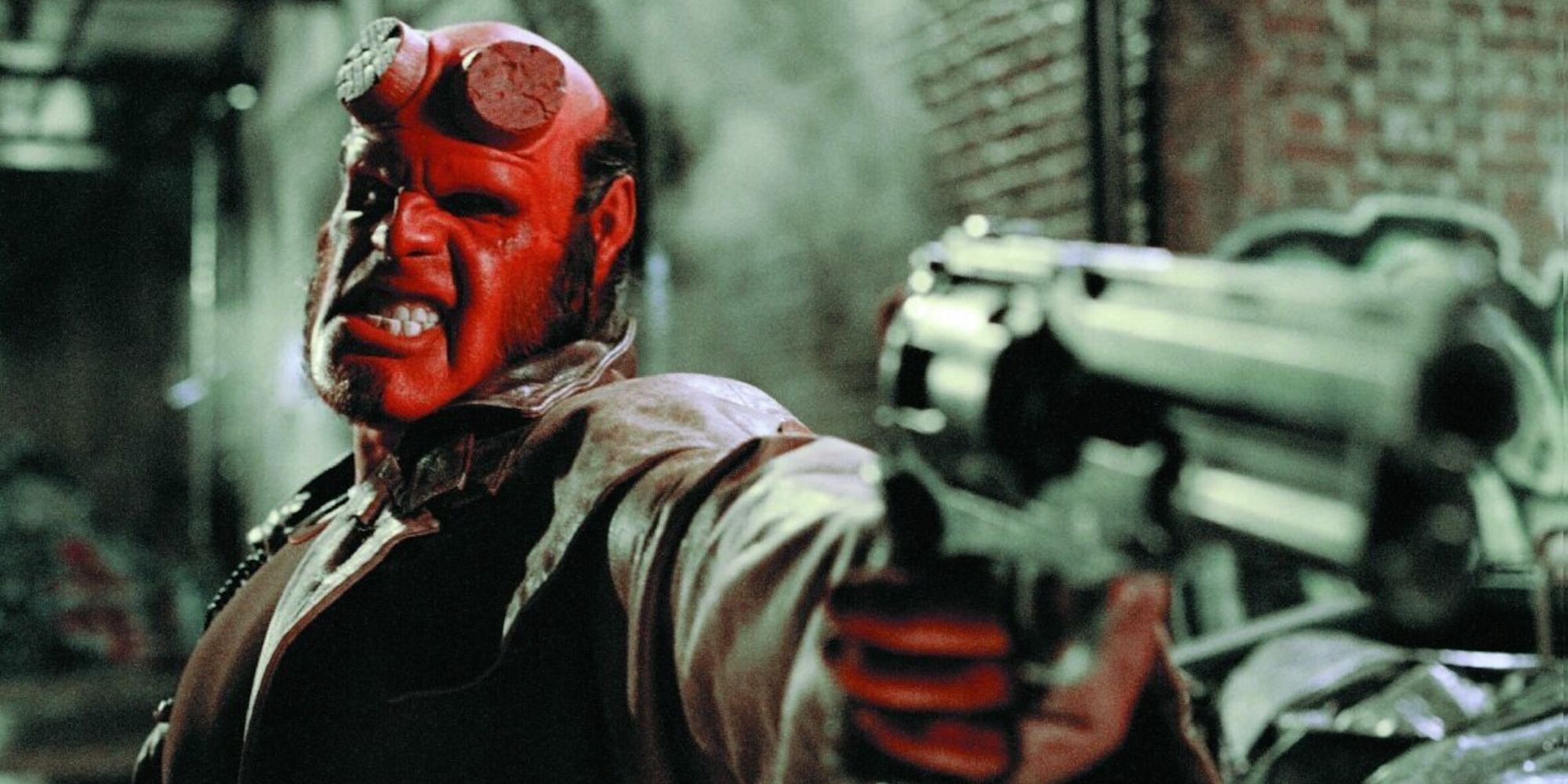 Ron Perlman as Hellboy holding a revolver