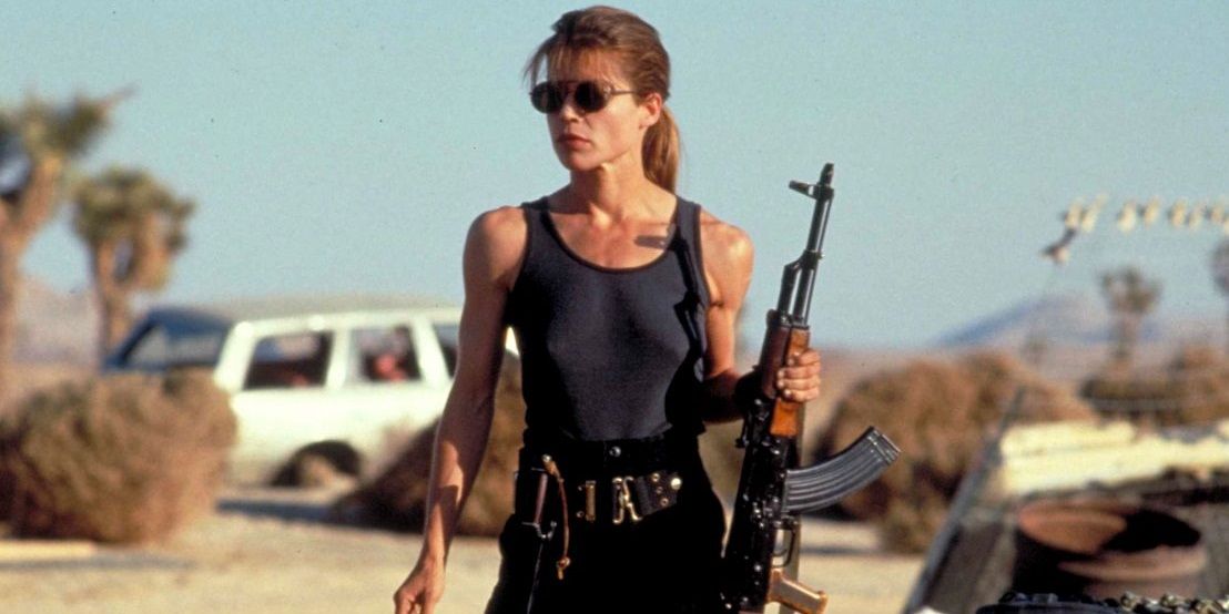 Sarah Connor holding a gun in the desert in Terminator 2