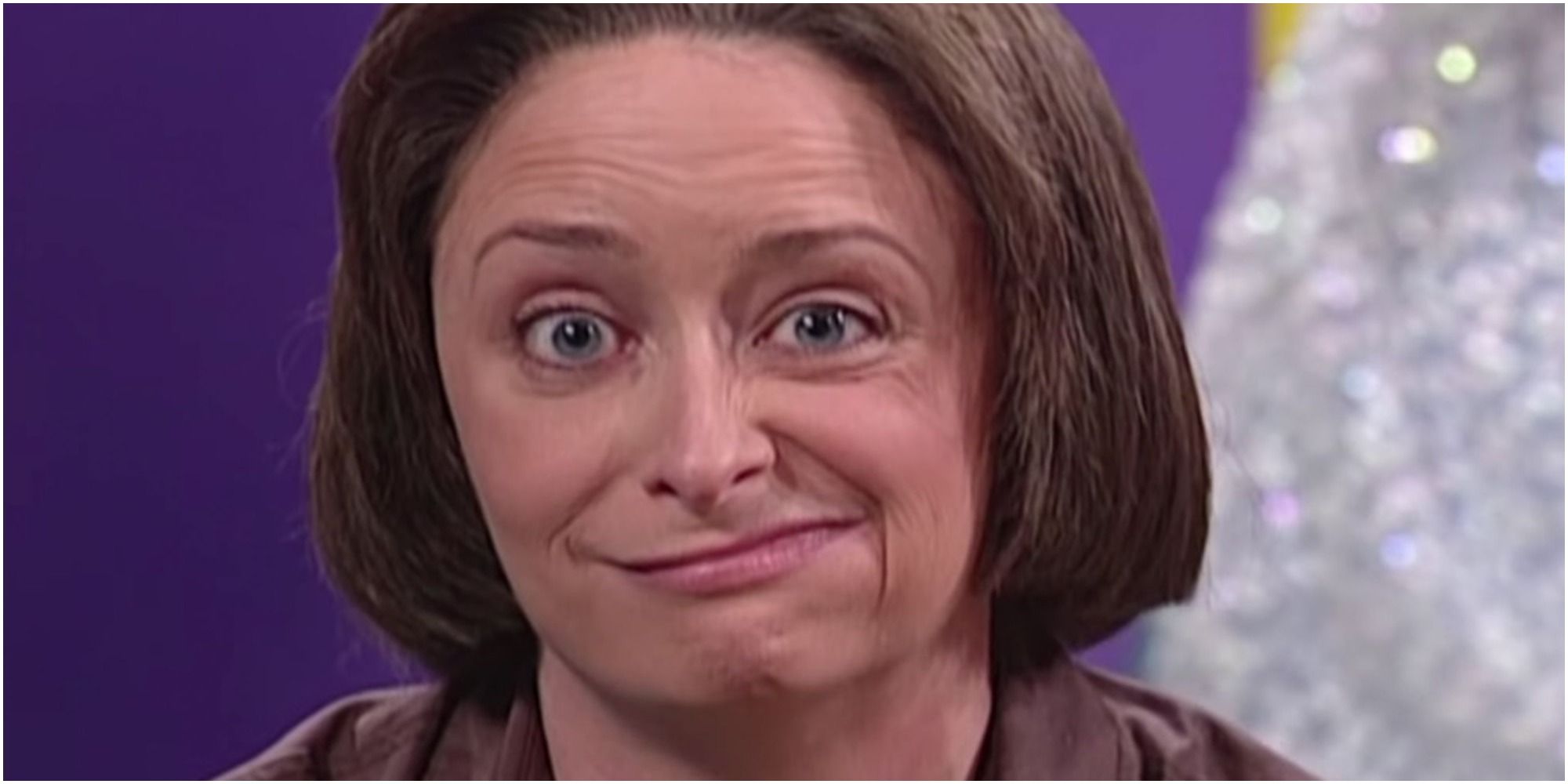 A screenshot of Debbie Downer looking at the camera with a knowing face in Saturday Night Live