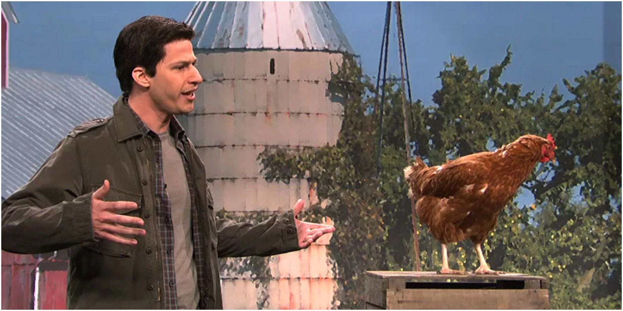 A screenshot of Andy Samberg's Mark Wahlberg talking to a chicken in Saturday Night Live
