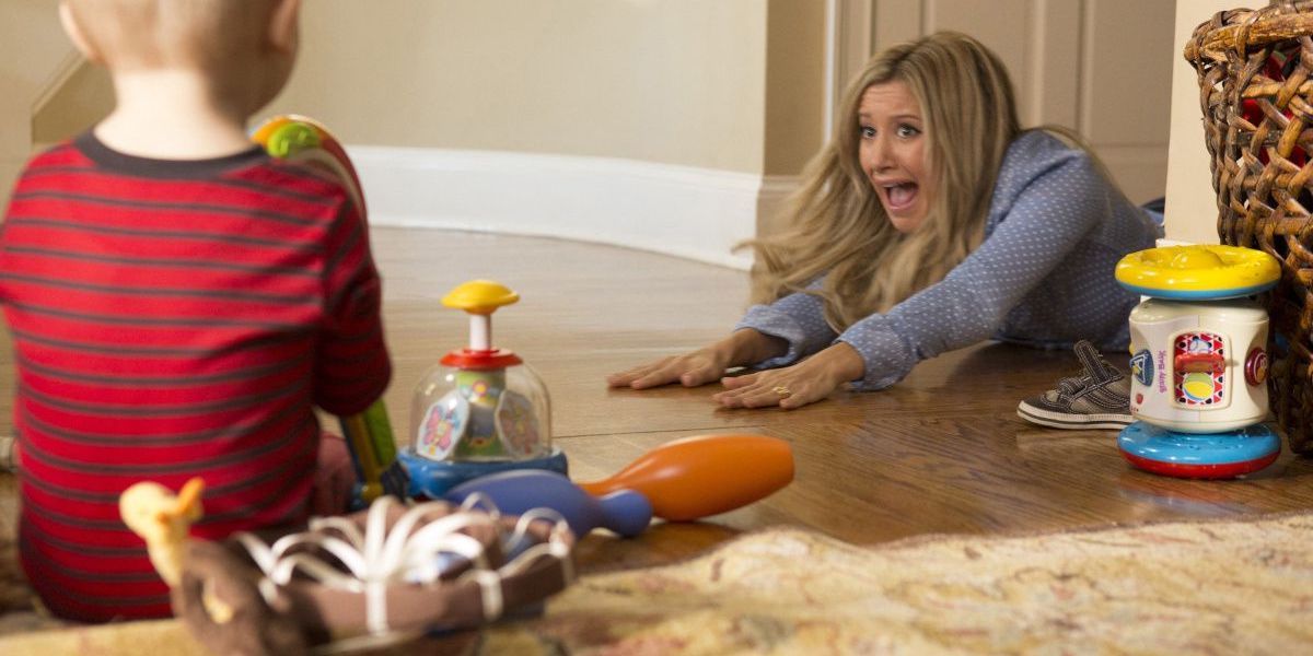 Ashley Tisdale as Jodi screaming on the floor as a baby looks on in Scary Movie 5