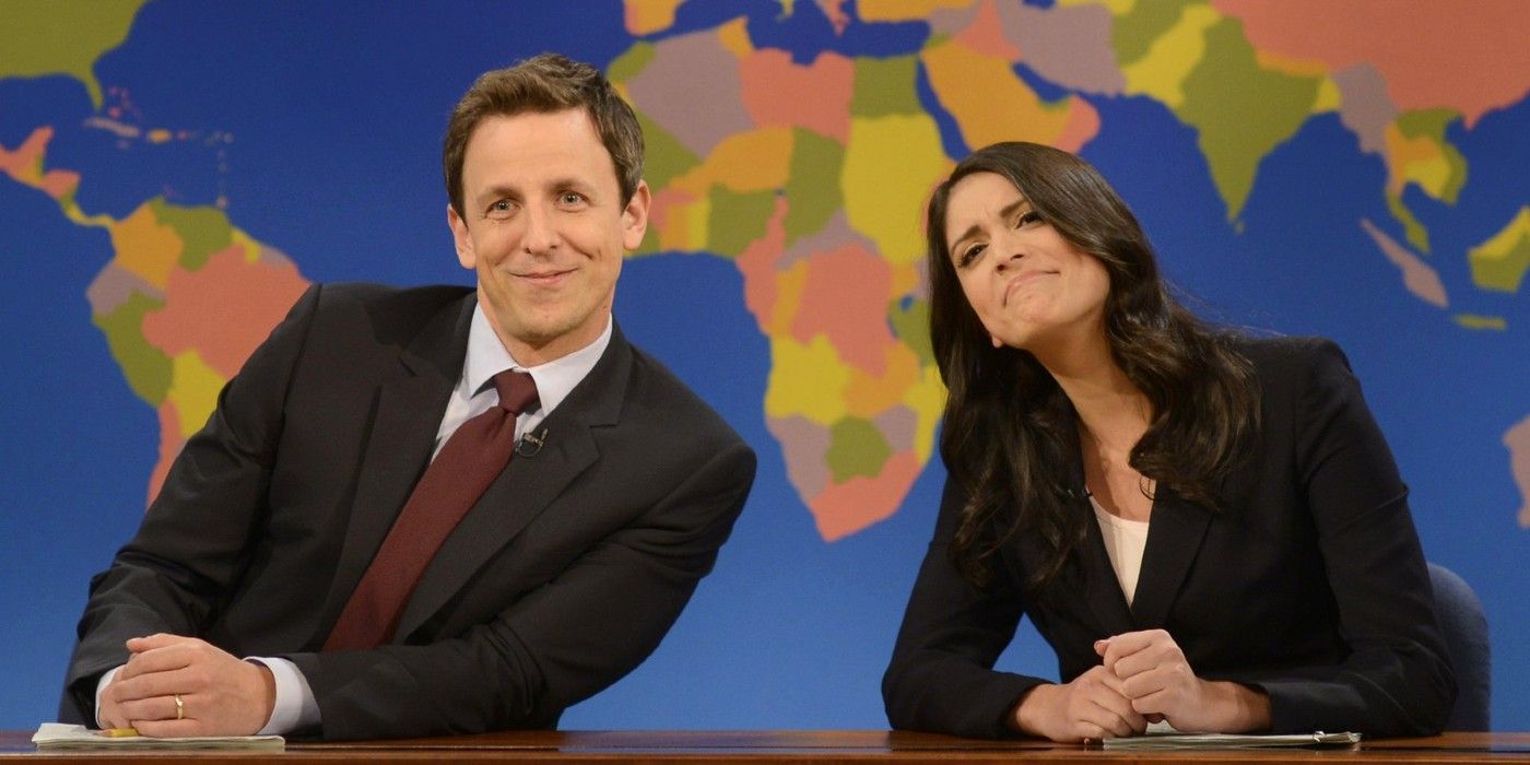 Seth Myers poses with Cecily Strong on the Weekend Update set.
