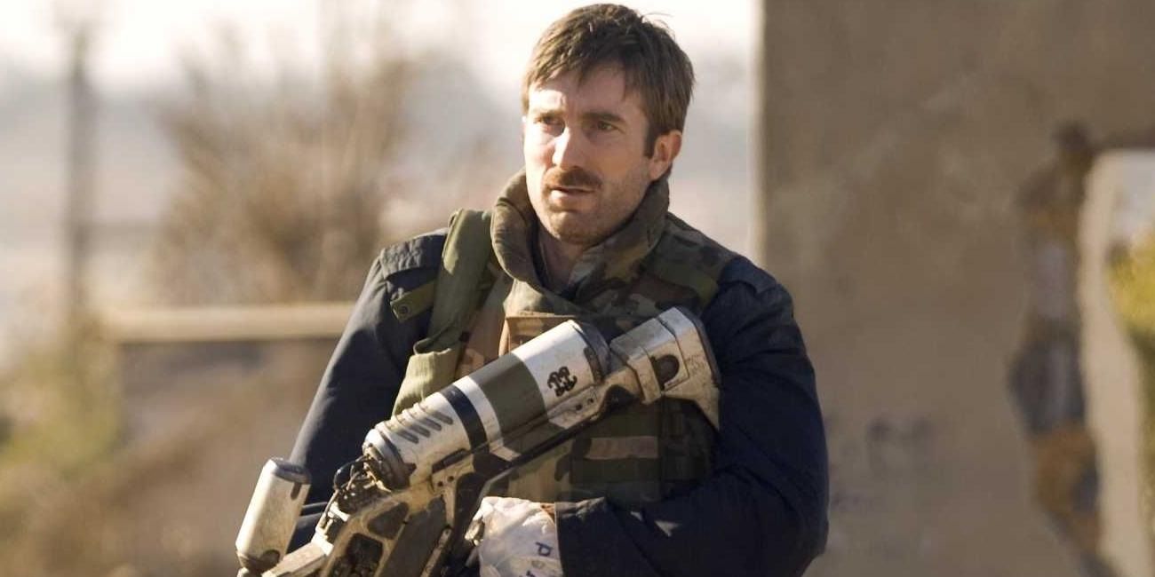 Sharlto Copley holding a gun in District 9