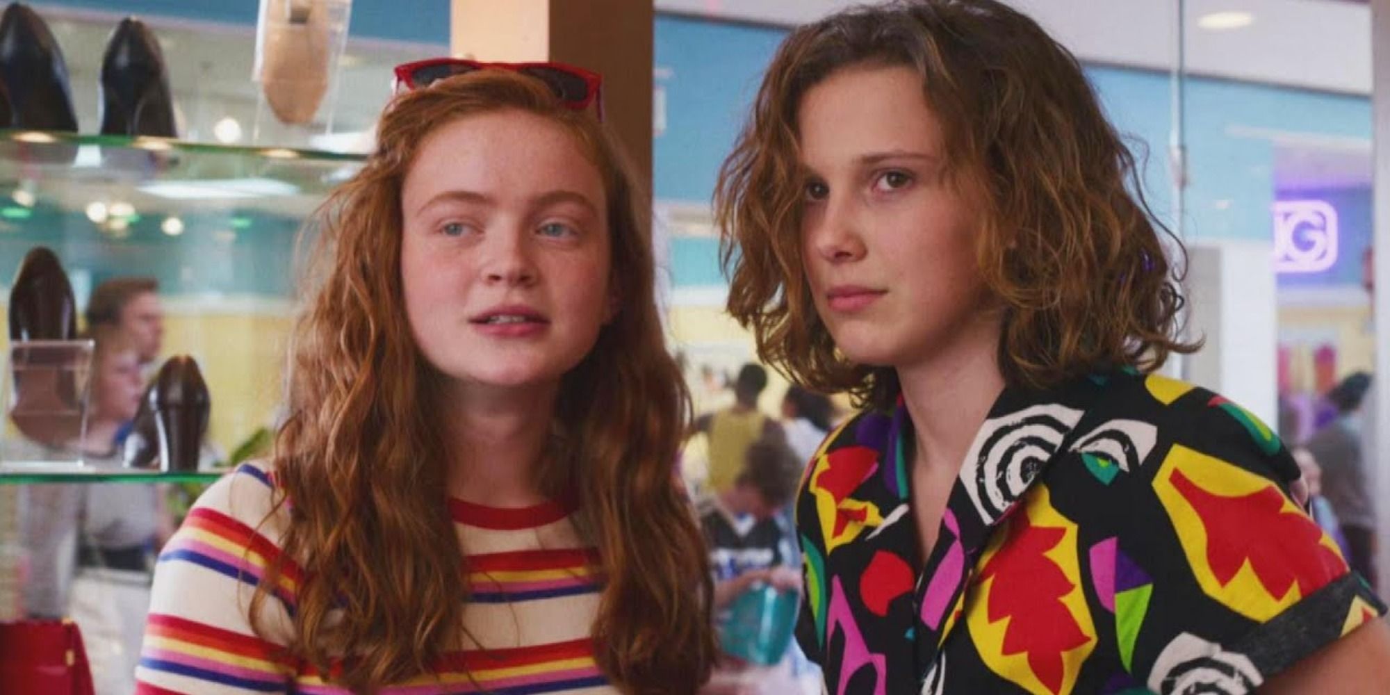 A screenshot of Max and Eleven spotting the boys inside the Starcourt Mall in Stranger Things