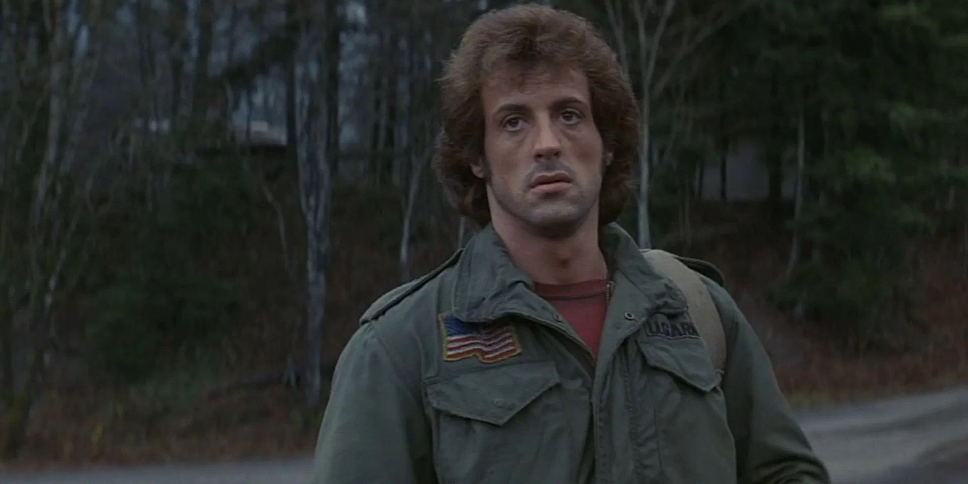 Sylvester Stallone as John Rambo walking into town in First Blood