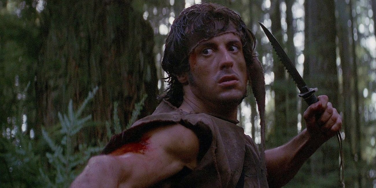 Sylvester Stallone as Rambo holding a knife in First Blood
