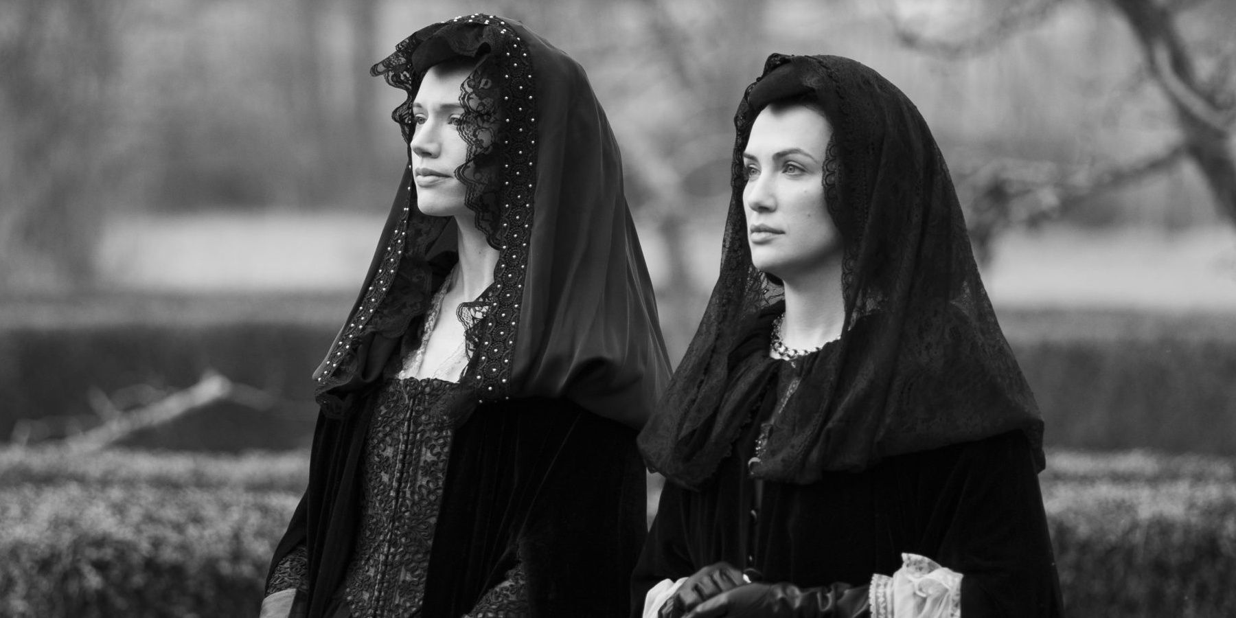 The Willoughby sisters, Perdita and Viola, stand solemnly in The Haunting of Bly Manor