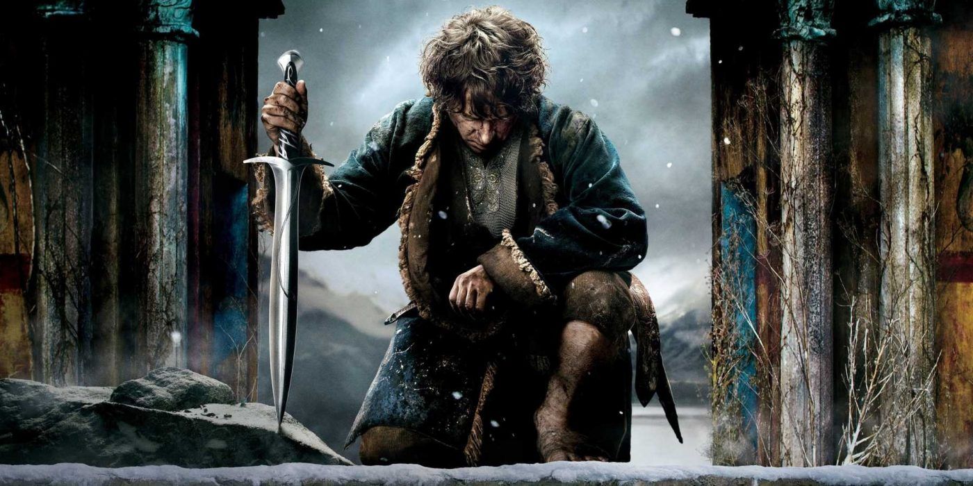 Bilbo kneeling while holding his sword and looking down from The Hobbit The Battle of the Five Armies