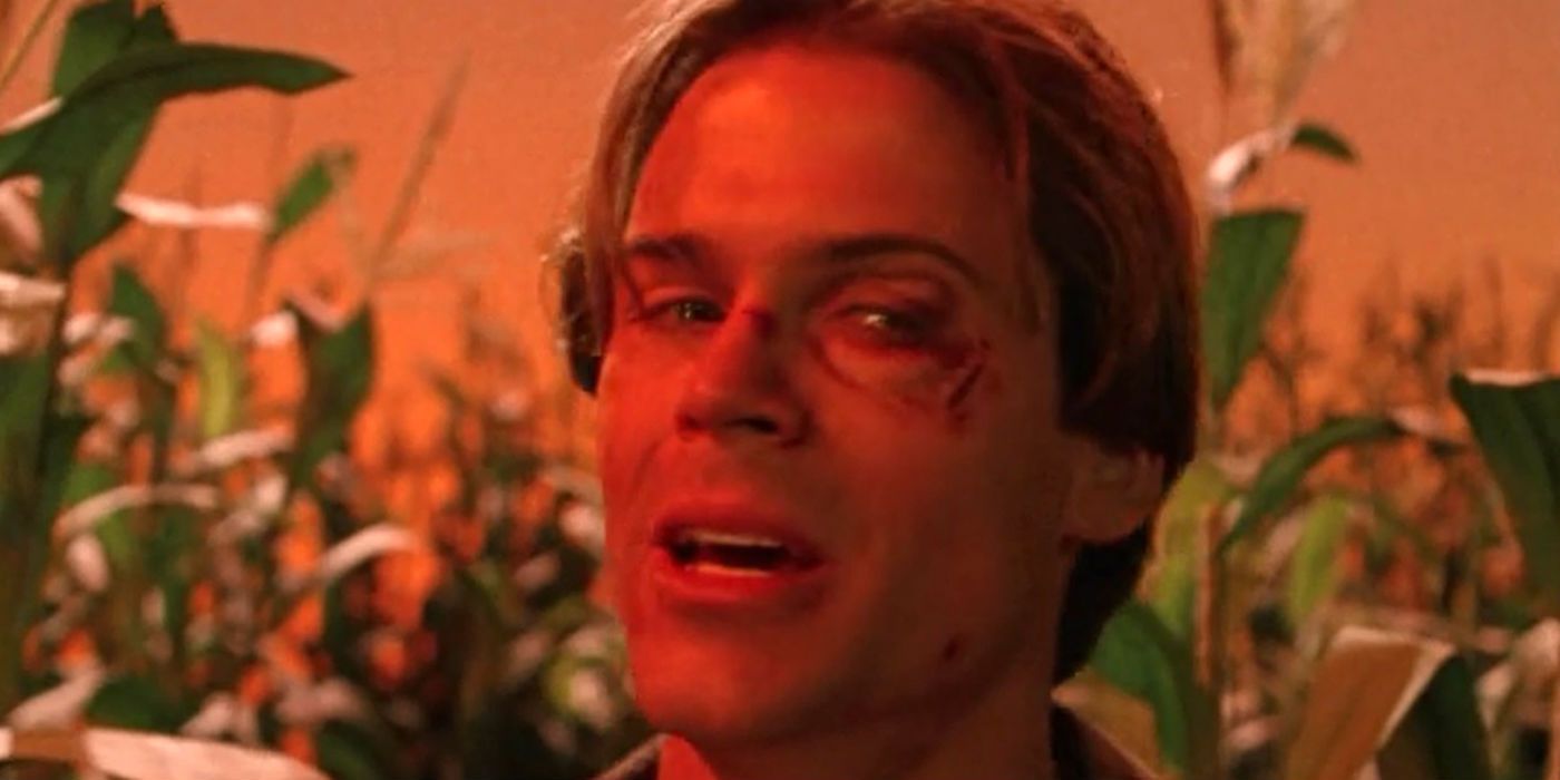 Rob Lowe as Nick Andros looking sideways with cuts on his face