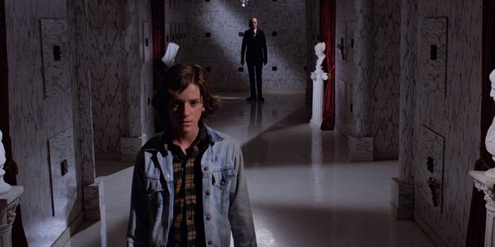 The Tall Man lurks in the background as a young man looks on from Phantasm