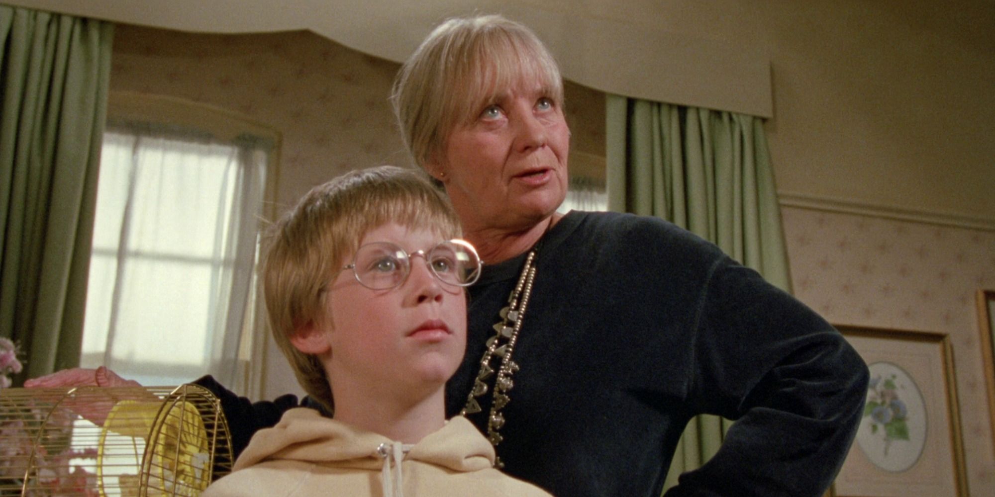 A screenshot of Luke and his Grandmother Helga checking in their hotel room in The Witches (1990)