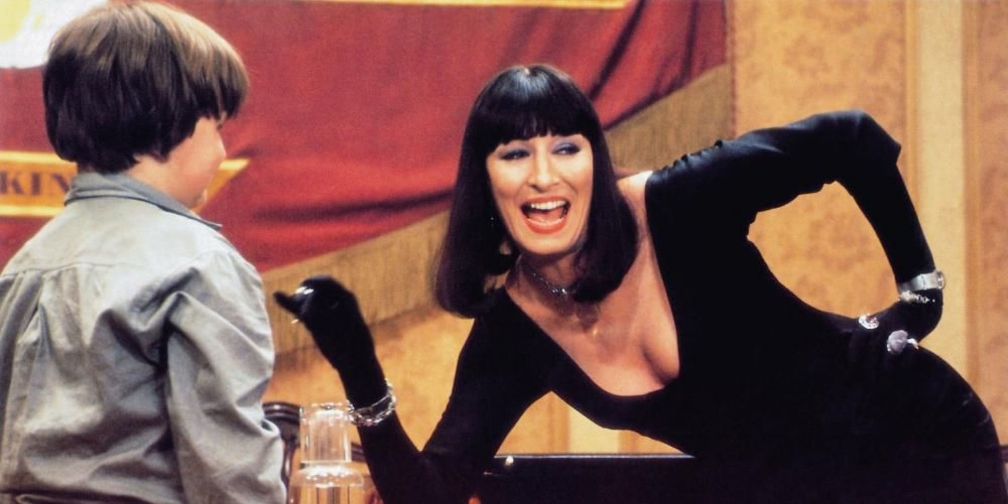 A screenshot of Anjelica Huston's Grand High Witch luring Bruno Jenkins in The Witches (1990)
