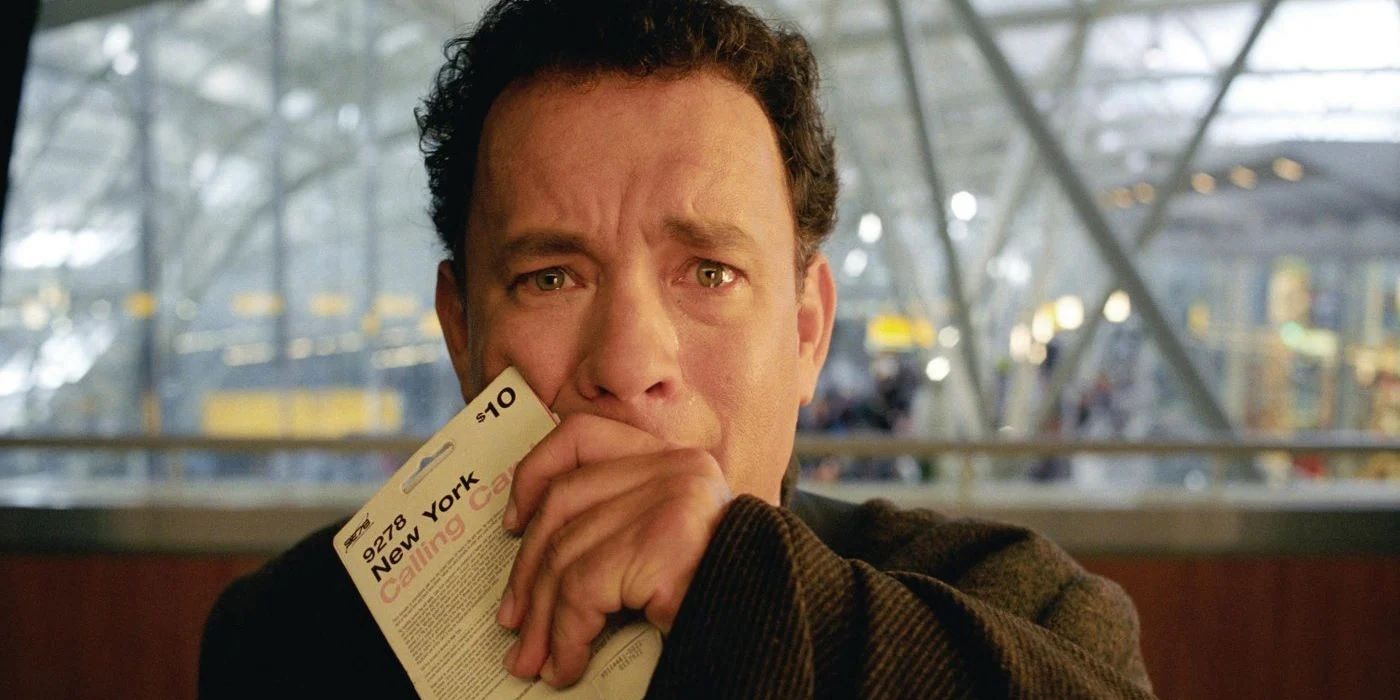 Tom Hanks cries and puts his hand to his mouth in The Terminal.