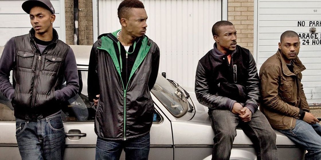 The Top Boy cast sitting on a car staring away from a camera