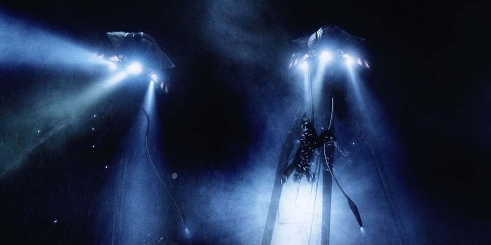 The alien tripods scoop up humans from the water in War of the Worlds