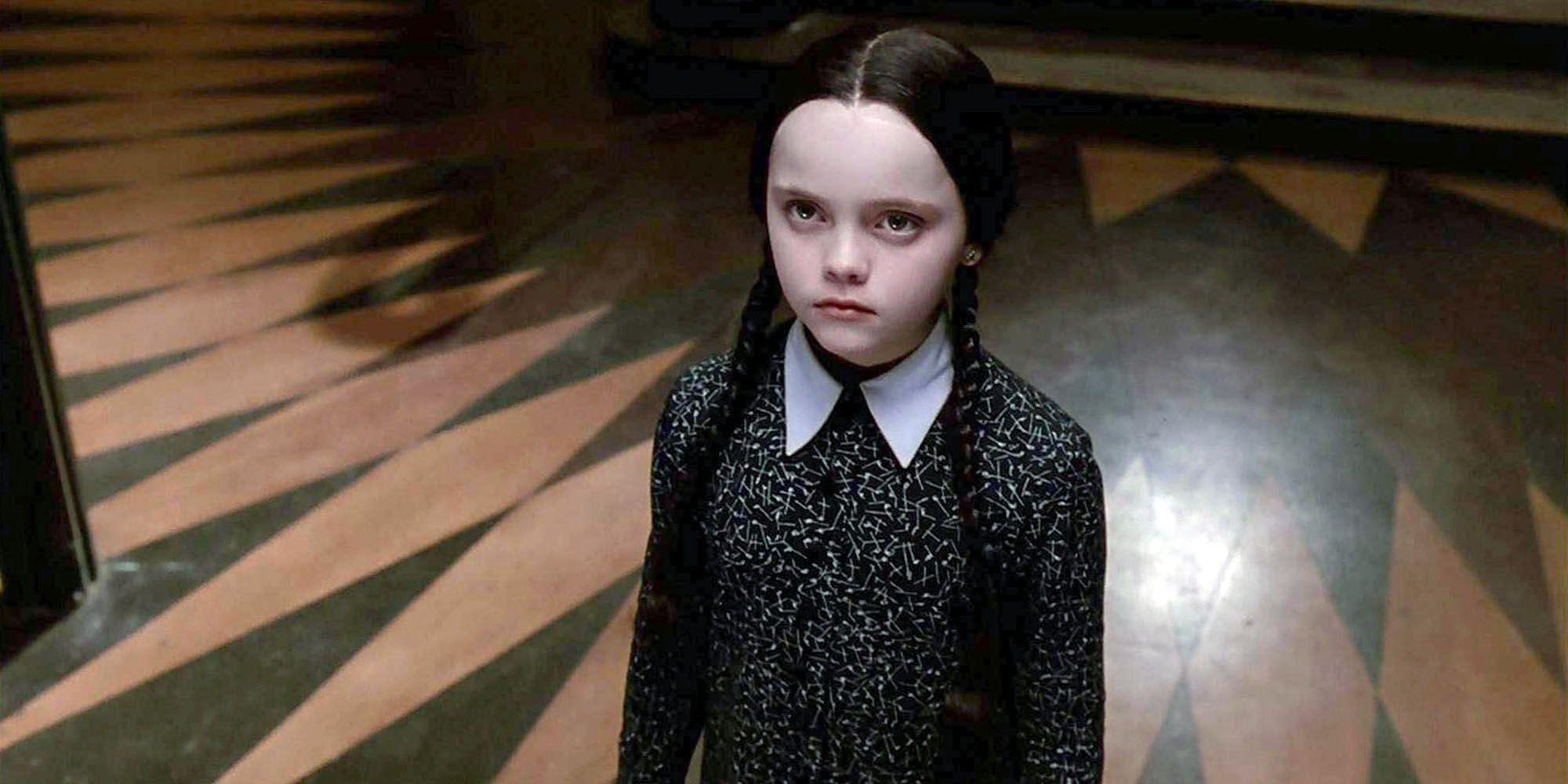 Wednesday Addams sulks by herself in The Addams Family