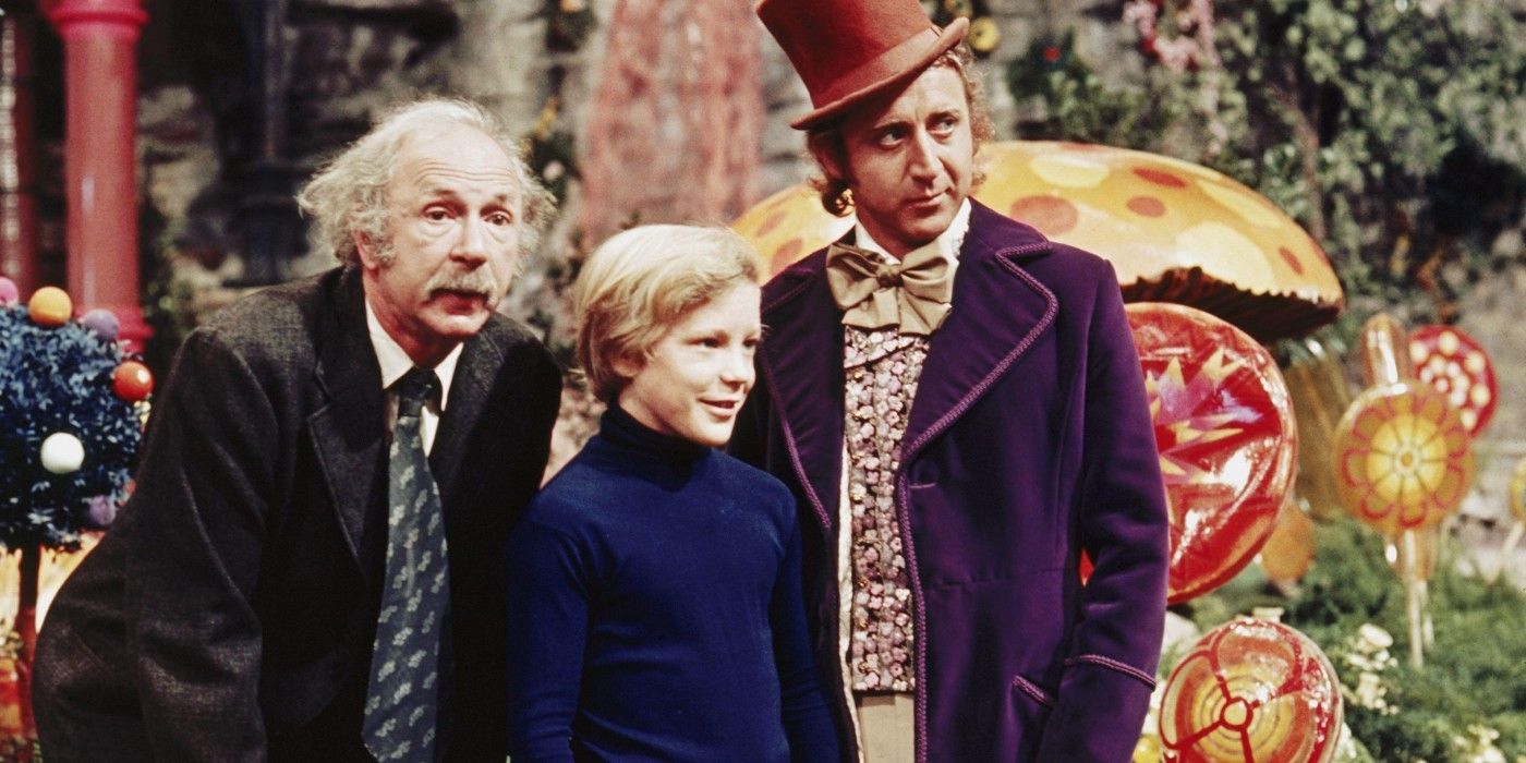 Grandpa Joe, Charlie, and Willy Wonka standing in the Chocolate Room