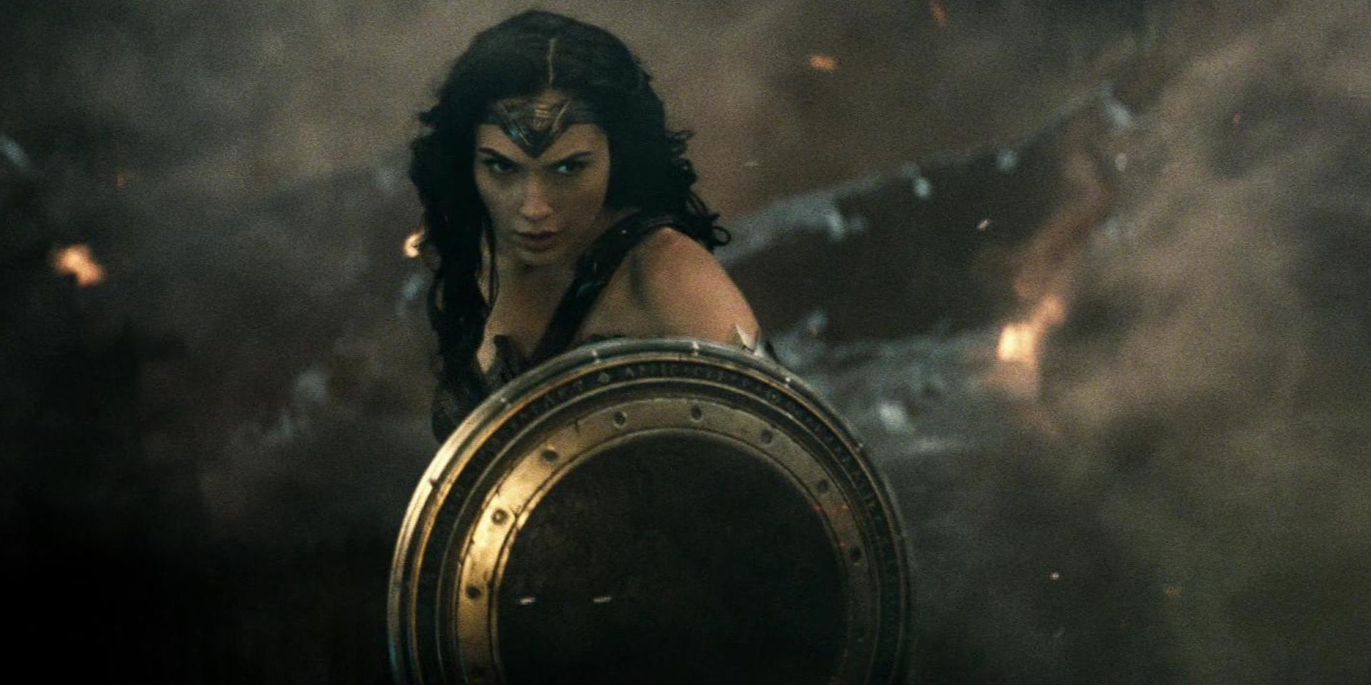 Wonder Woman in Batman v Superman holding her shield up in the rubble in the final battle