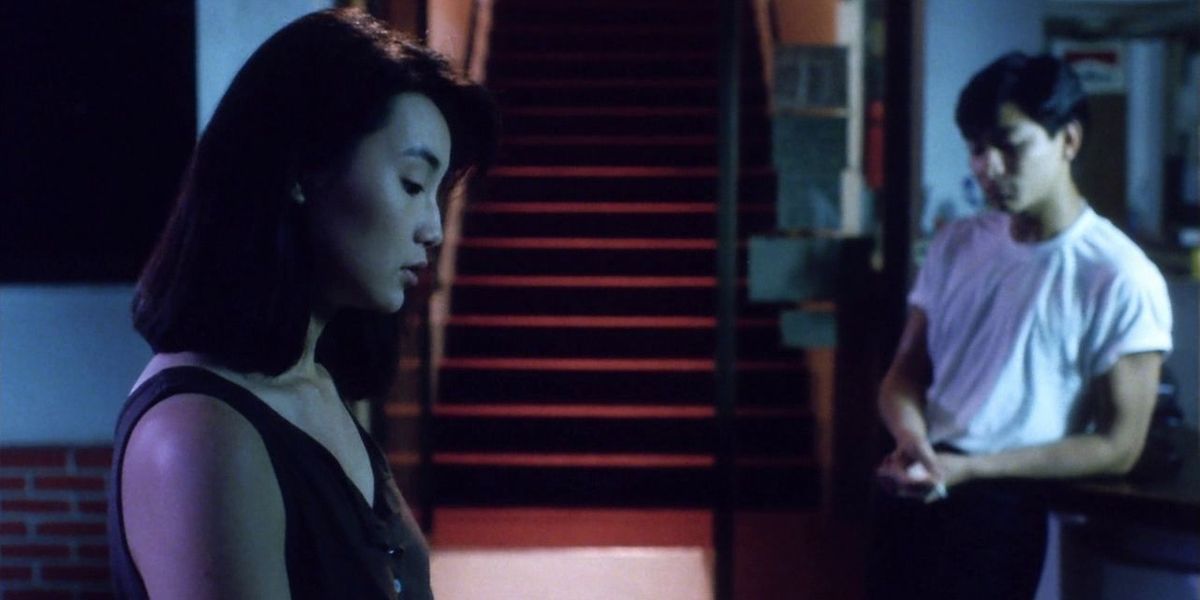 Andy Lau and Maggie Cheung standing in a room silently in As Tears Go By