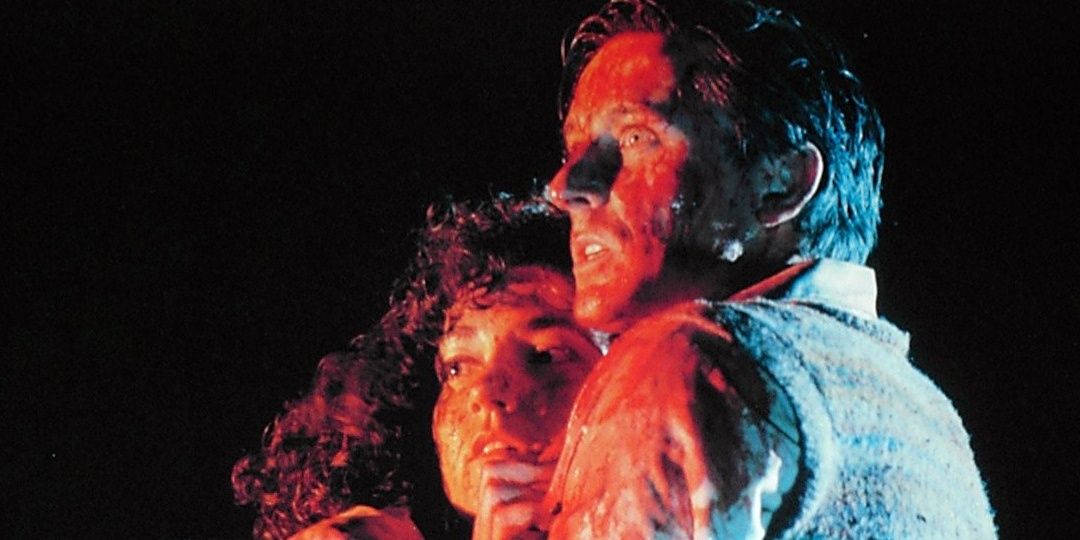 Lionel and Paquita embracing each other terrified in the poster for Braindead