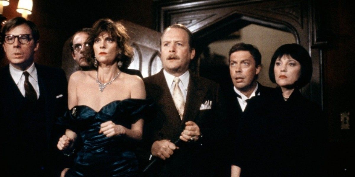 The cast of Clue gathers in the foyer to look at the murderer.