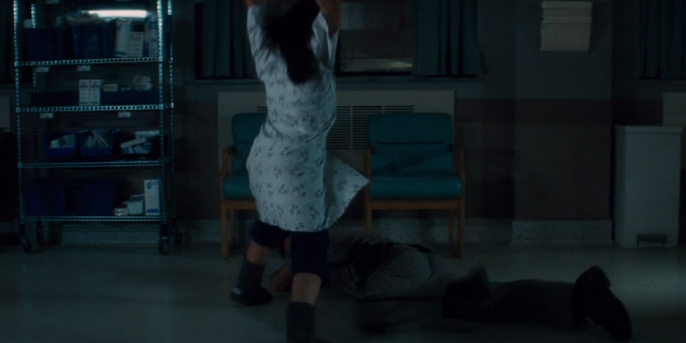 a white woman in a hospital gown beating a white cop with a bedpan