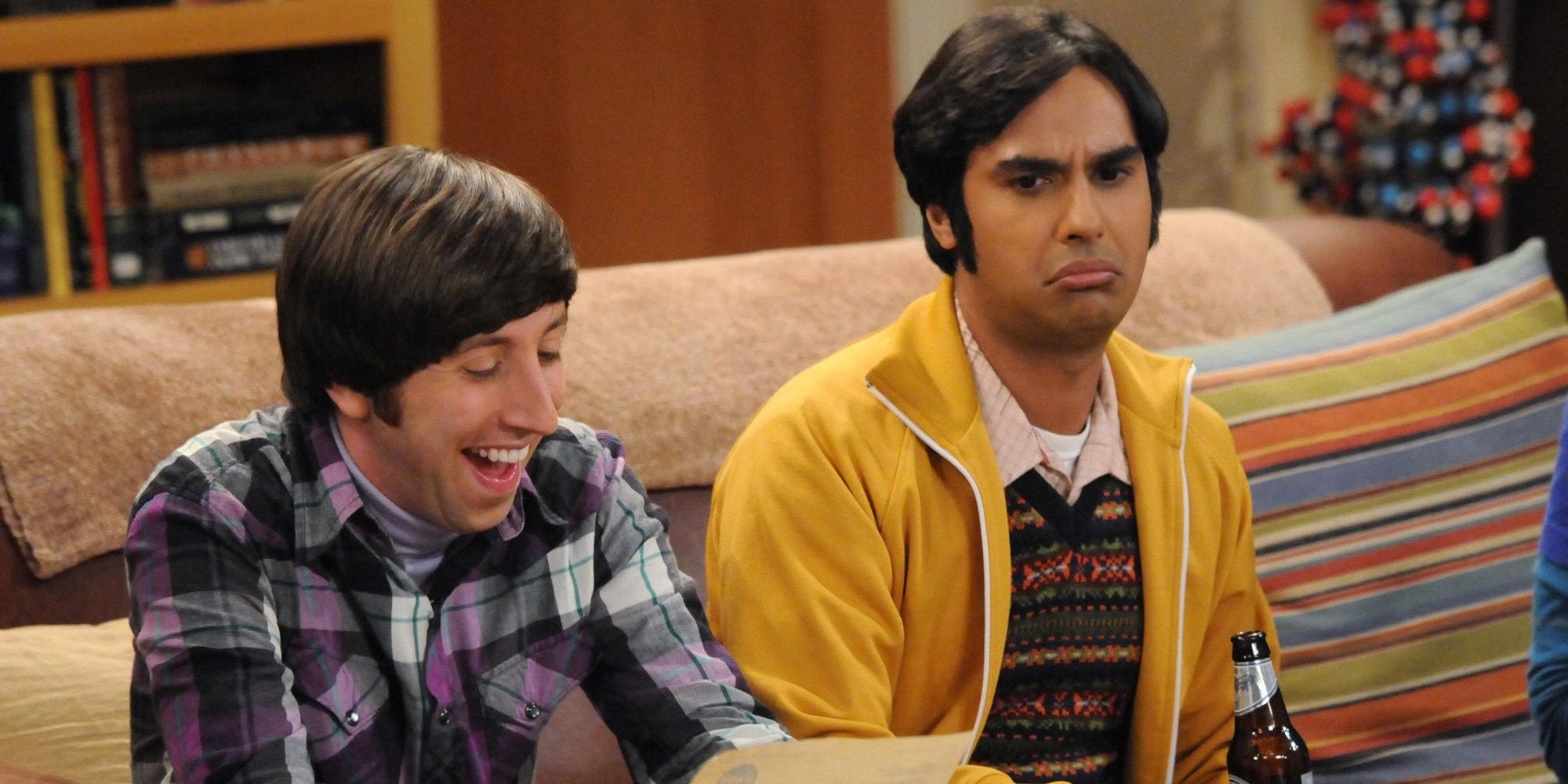 Howard laughs while Raj looks sad in The Big Bang Theory.