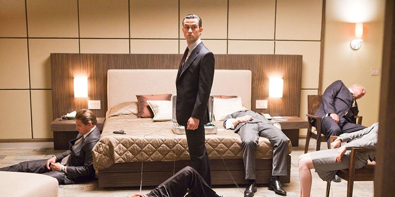 Arthur in a room with sleeping bodies in Inception