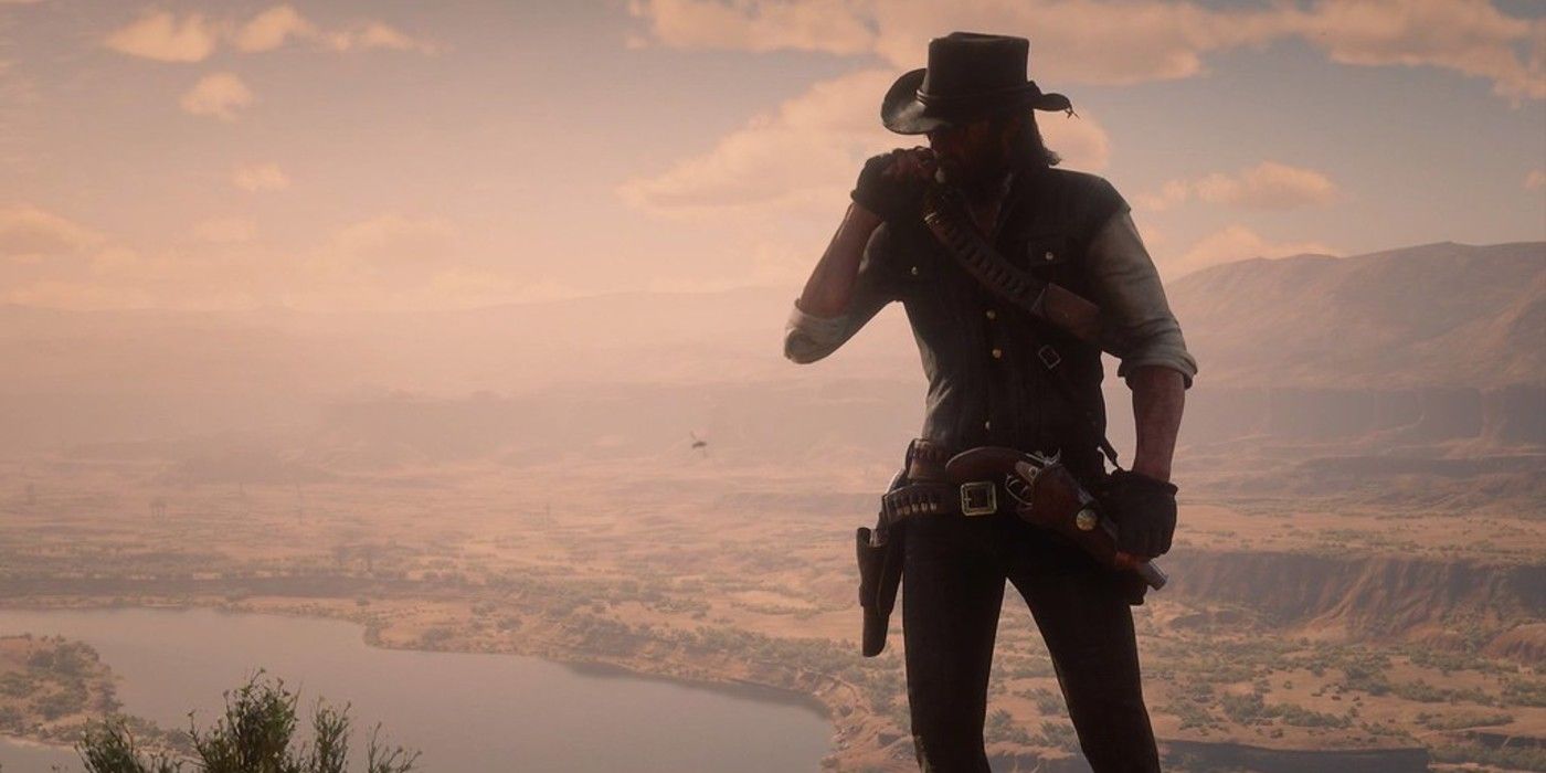 John Marston stands on a hill overlooking the city and the lake in Red Dead Redemption