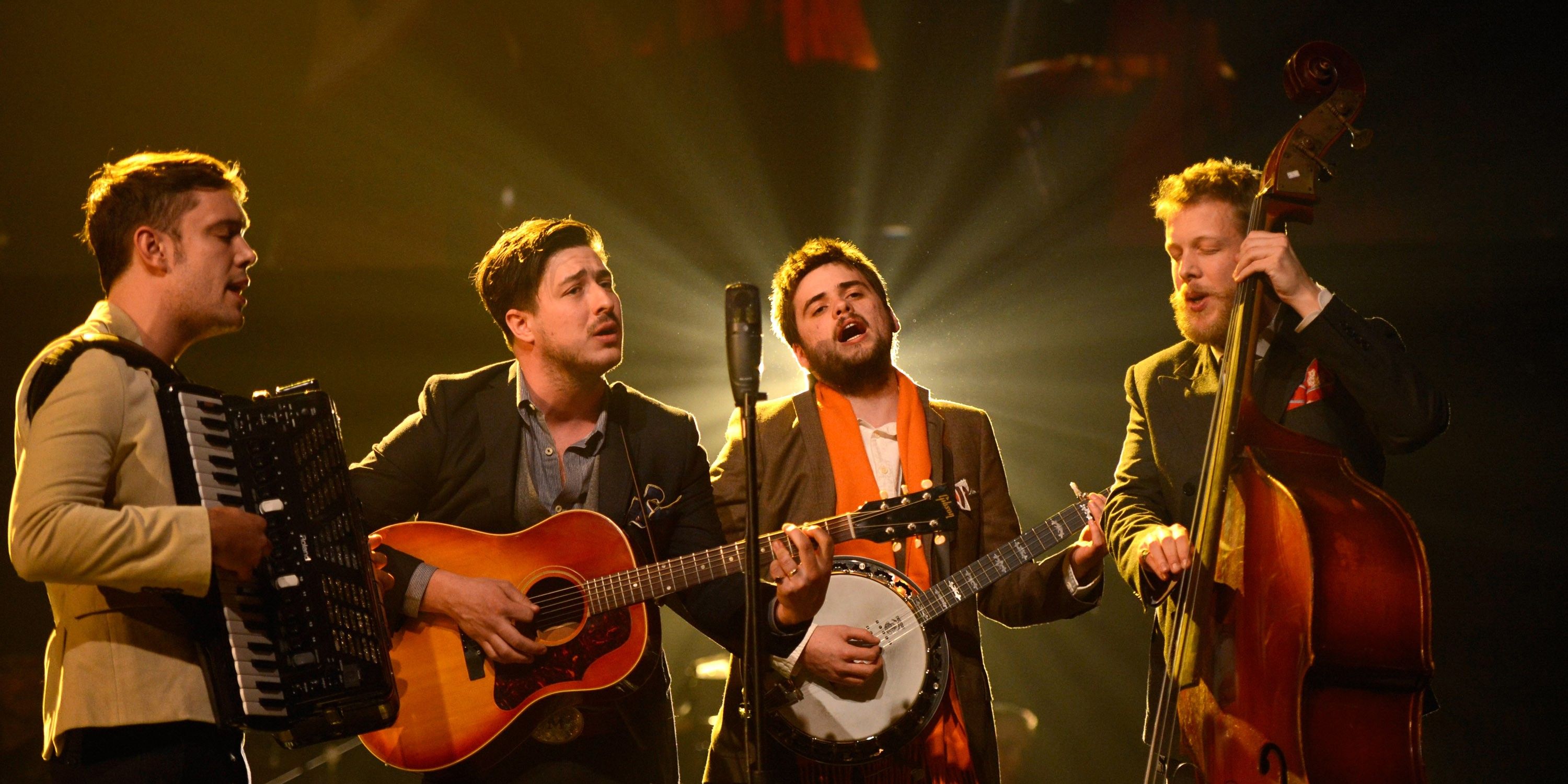 Mumford and Sons singing and playing instruments