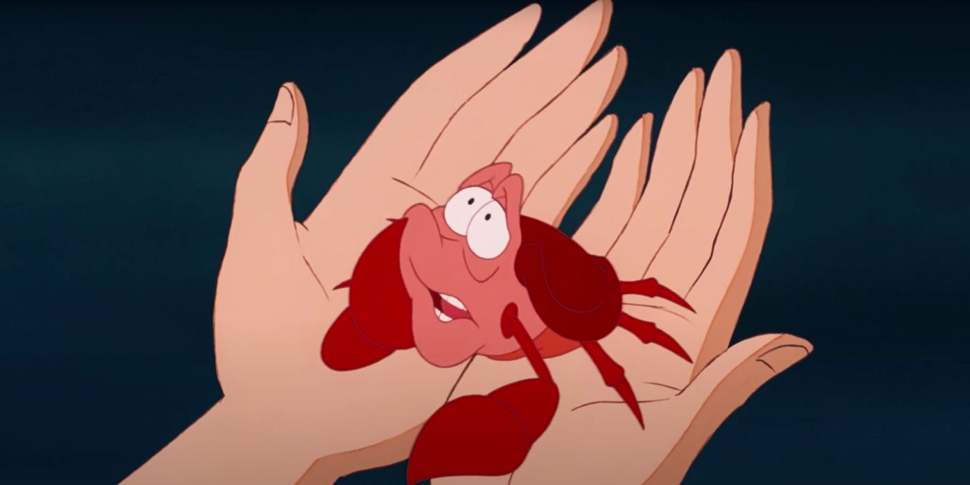 Sebastian in Ariel's hands in Disney's animated The Little Mermaid