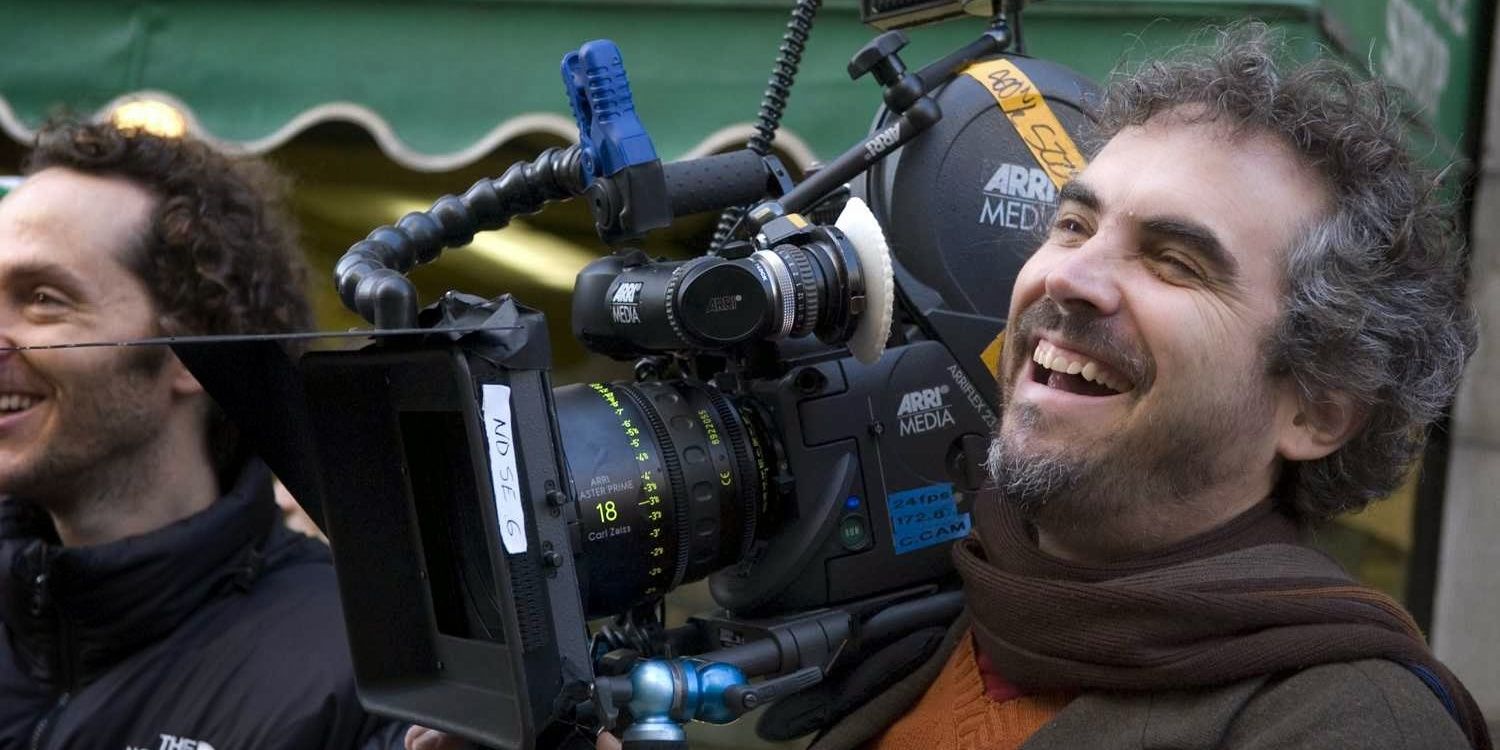 Alfonso Cuaron smiling holding movie camera