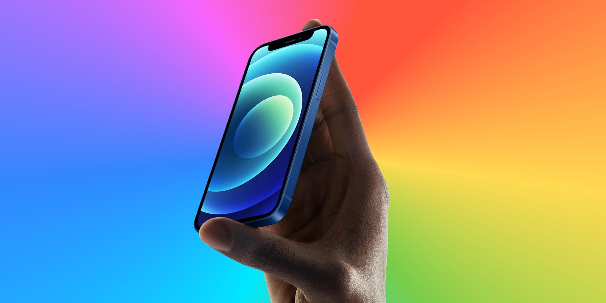An iPhone 12 mini on a rainbow background