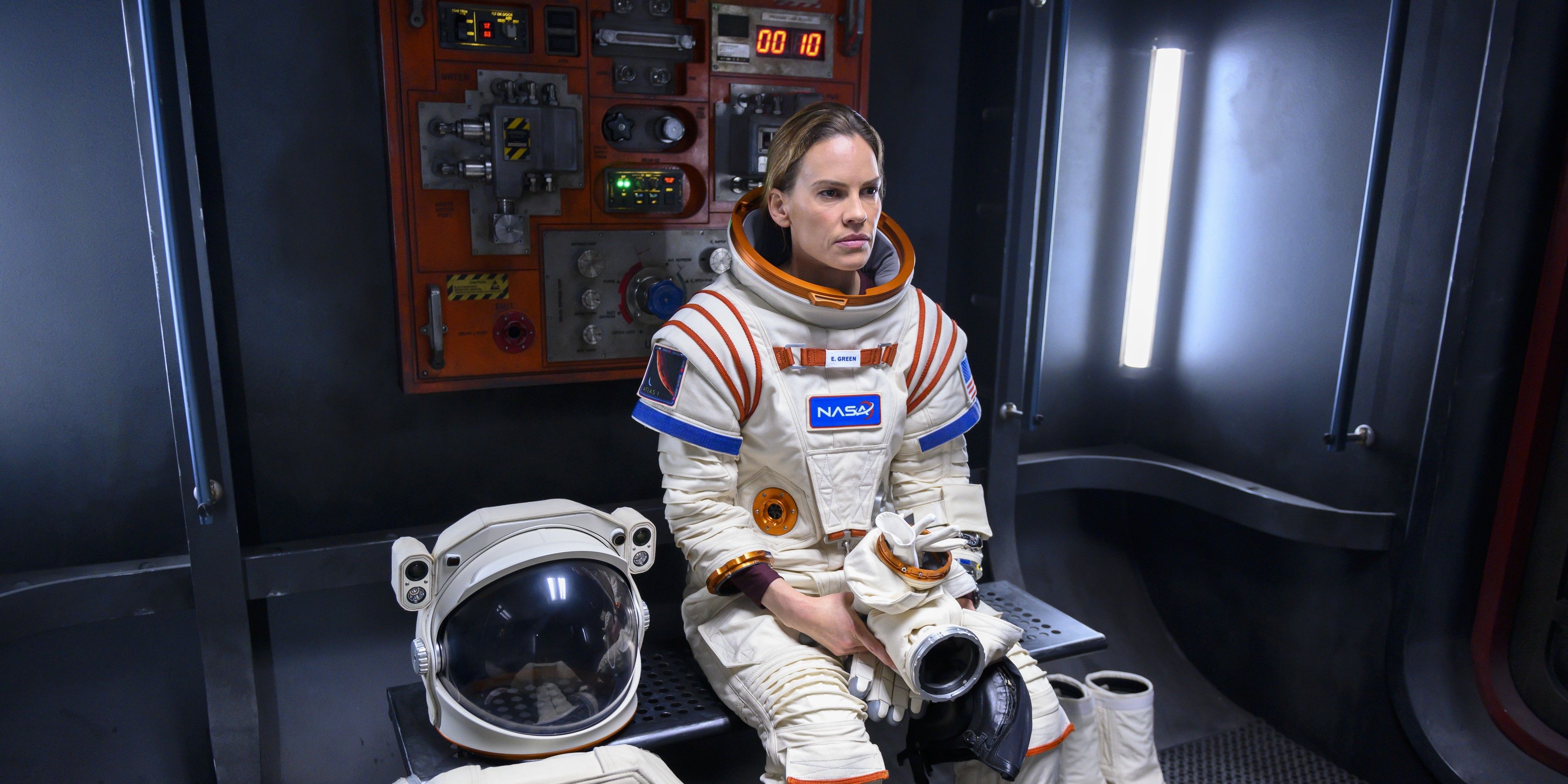 Emma sits alone in an astronaut suit in Away