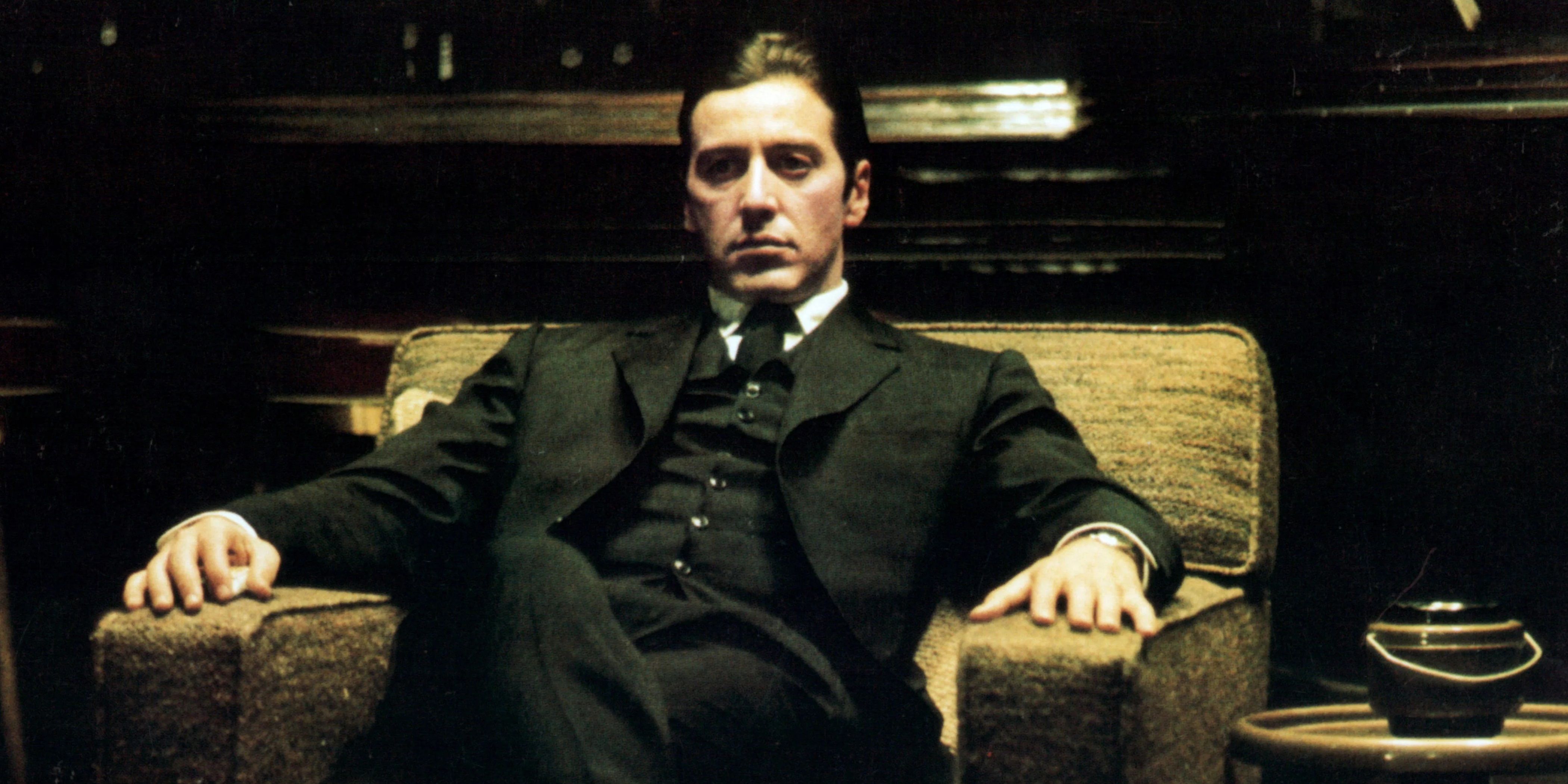 Al Pacino as Michael Corleone sitting in a chair in The Godfather Part II