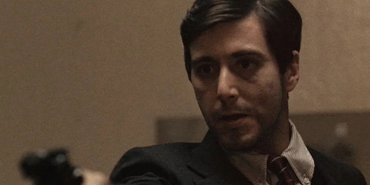 Al Pacino holding a gun in The Godfather