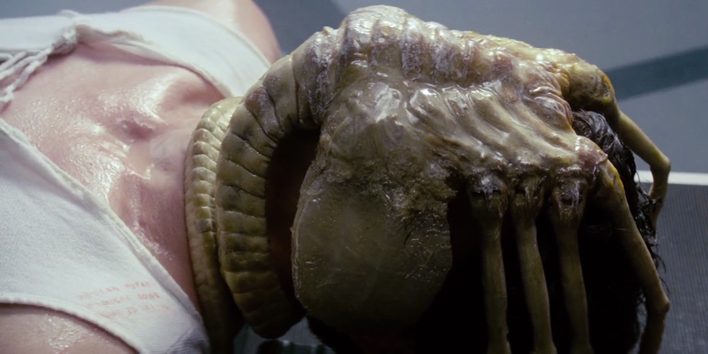 A comatose man lies still with a facehugger on his head in Alien.