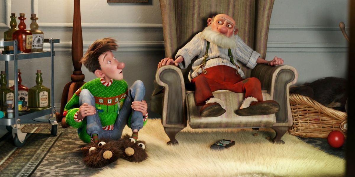 Arthur Christmas on the floor sitting next to his Grandfather 