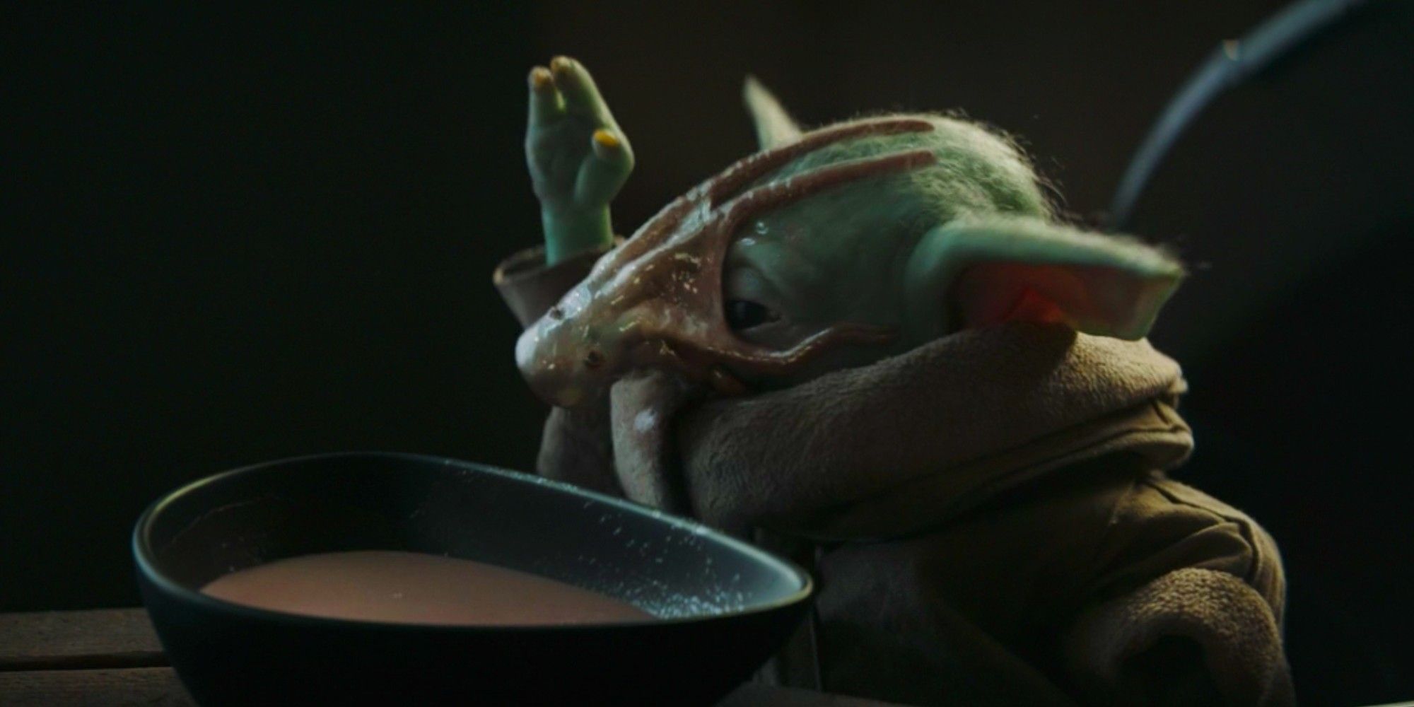Baby Yoda eating chowdered squid