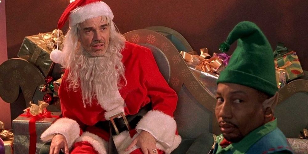 Billy Bob Thornton as Willie sitting on his chair, his friend Marvin the Elf beside him, both looking disgustedly at something in a scene from Bad Santa.