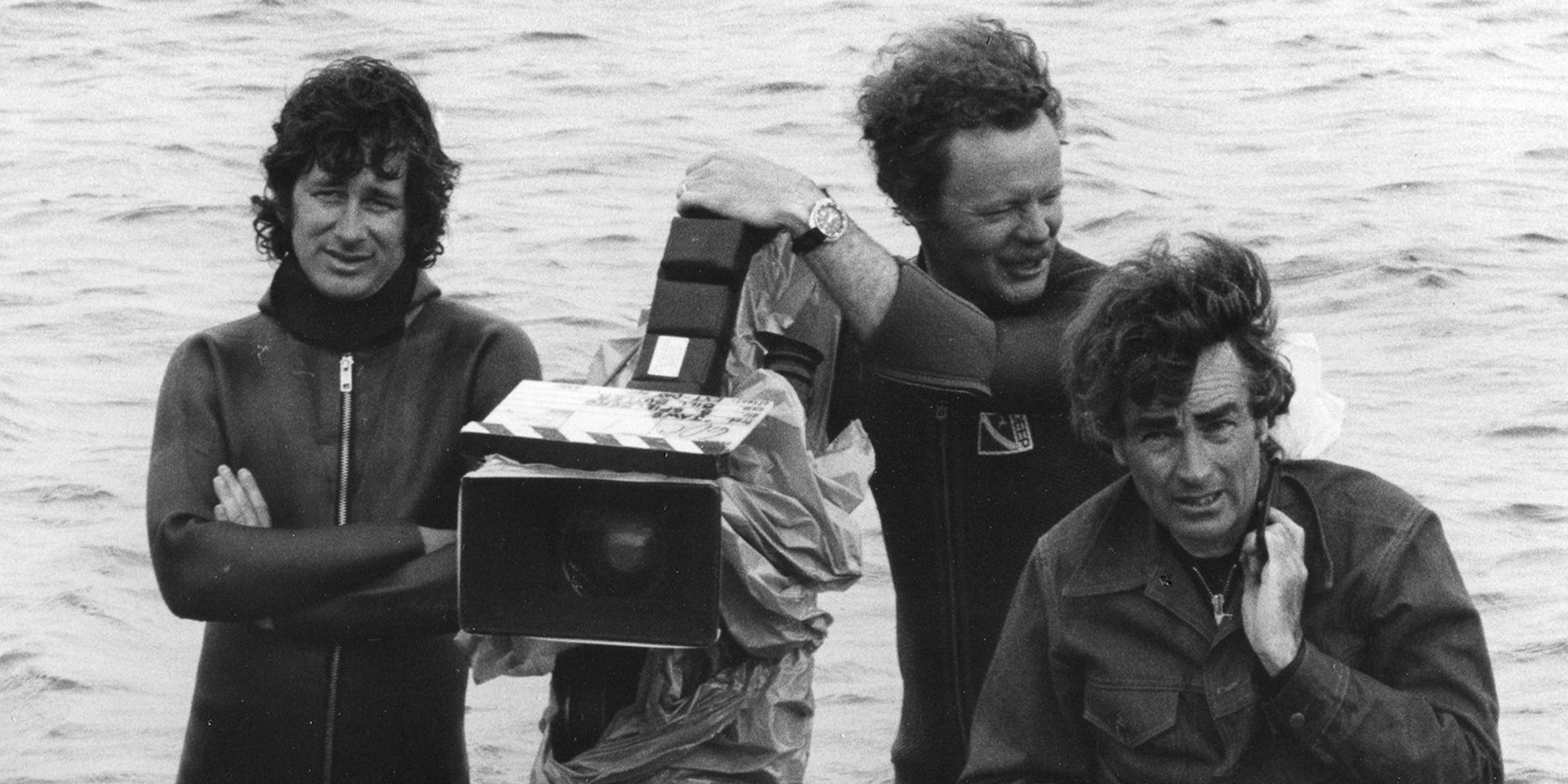 Behind the scenes photo of Steven Spielberg and crew members on the set of Jaws