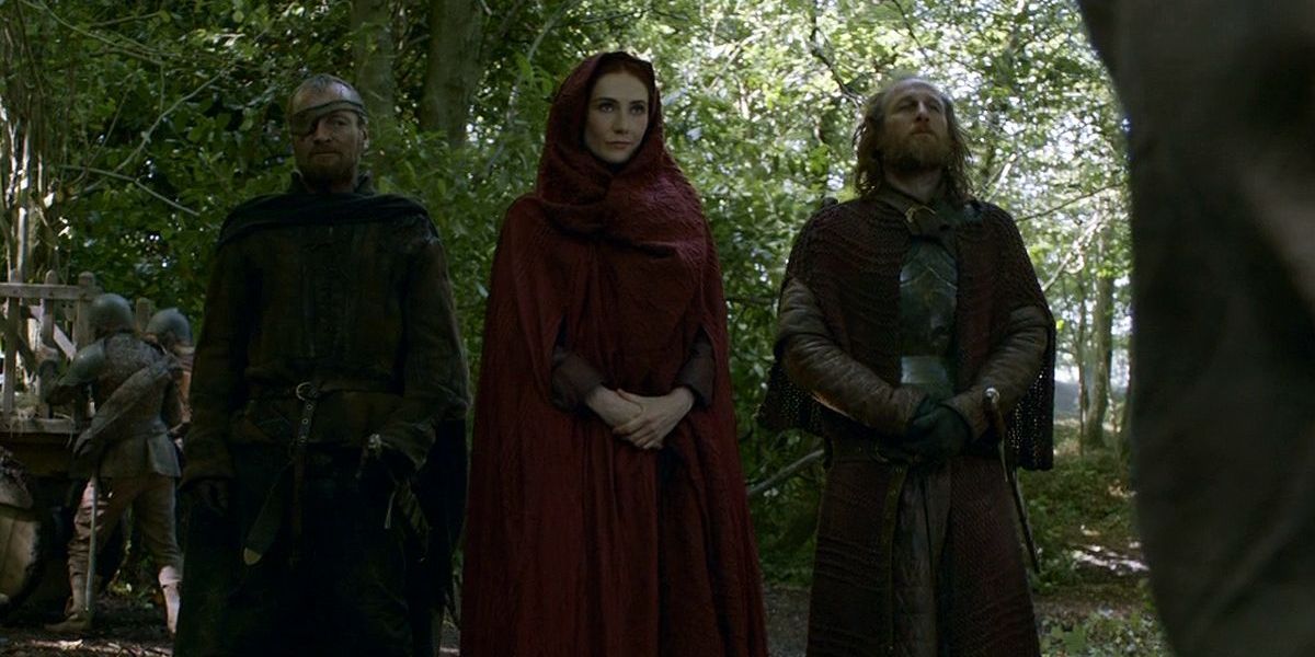 Beric Dondarrion, Melisandre, and Thoros of Myr standing in a forest in Game of Thrones.