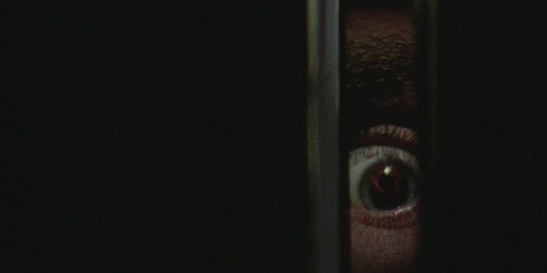 Billy's eye looking through a crack in Black Christmas (1974)