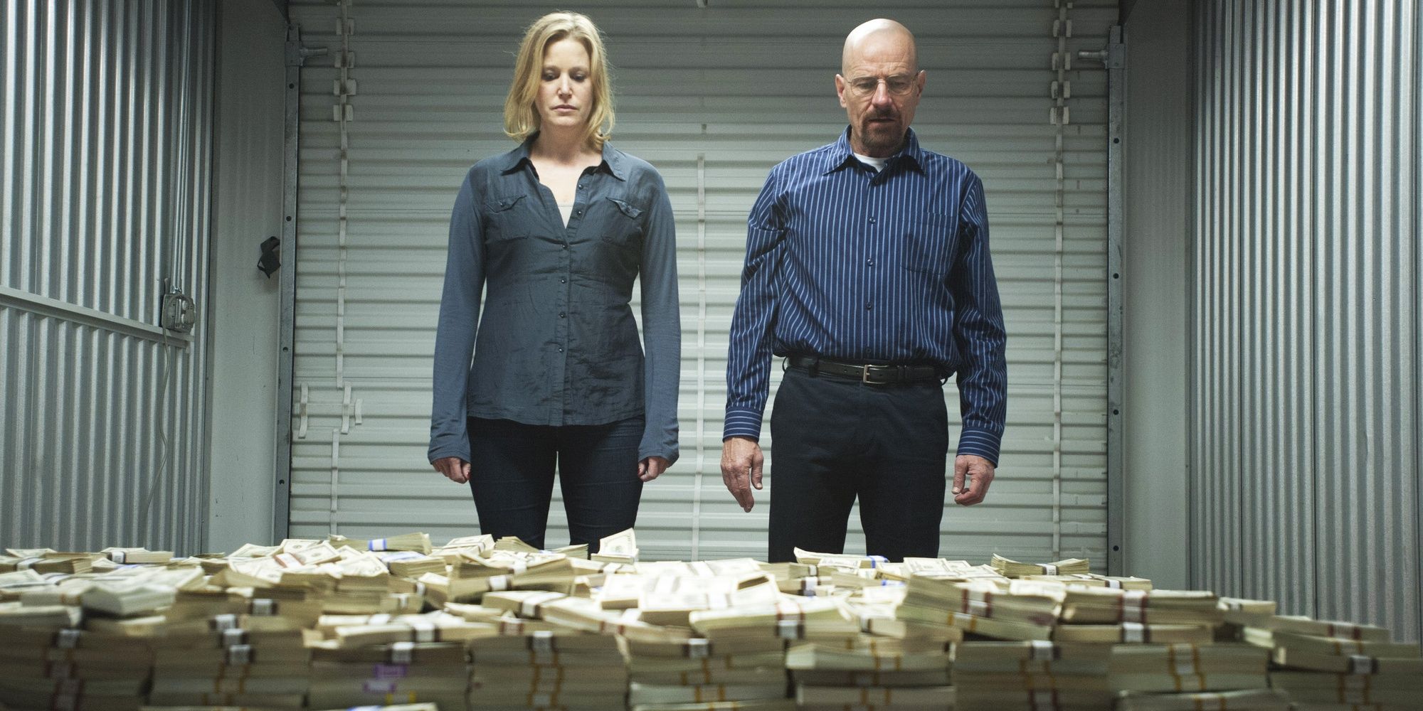 Walt and Skyler looking at a pile of money in Breaking Bad