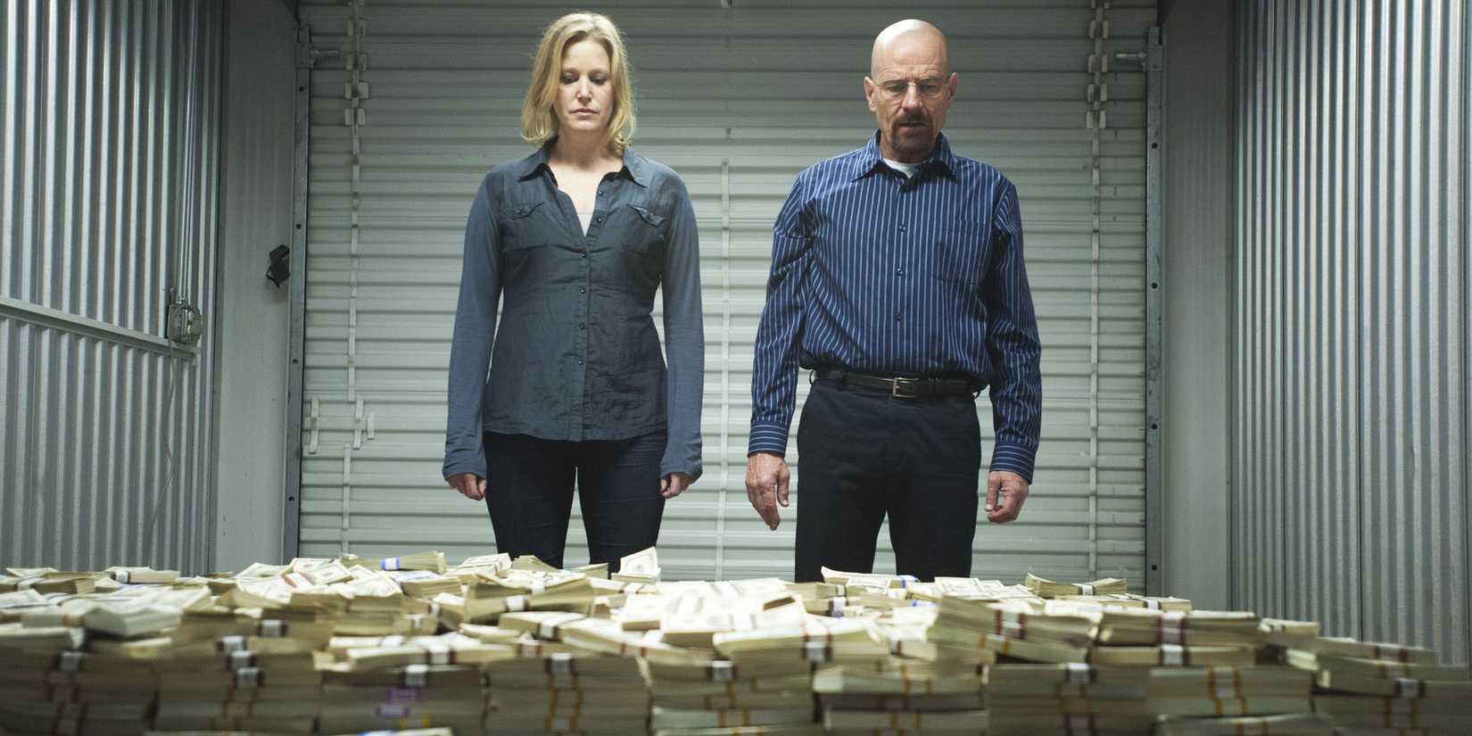 Walt and Skyler looking at a pile of money in Breaking Bad