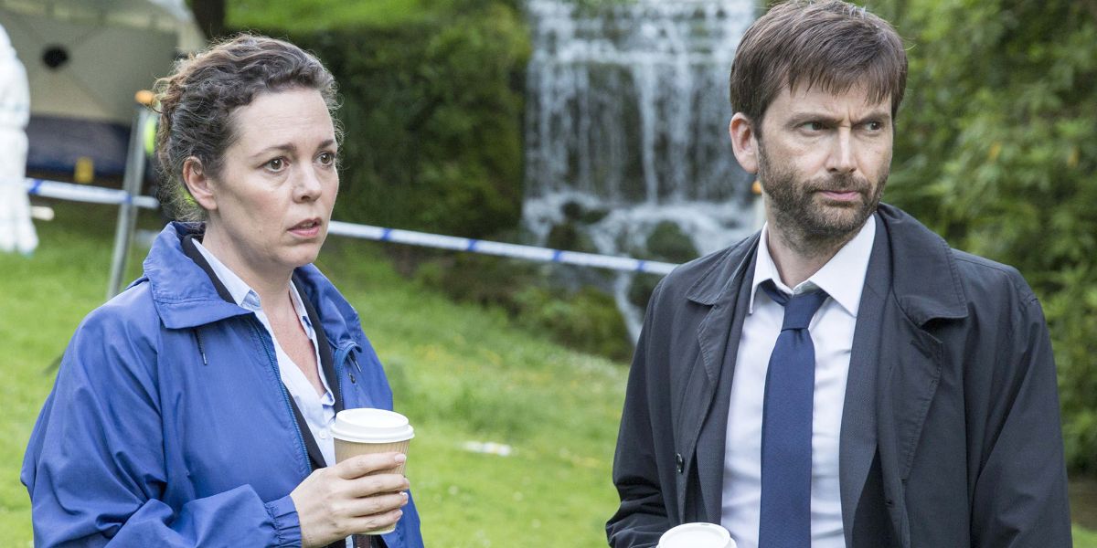 Ellie and Alec stand with cups of coffee at a crime scene in Broadchurch